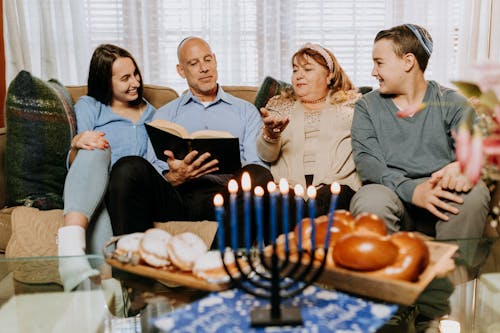 Photo Of Family Sitting On A Sofa