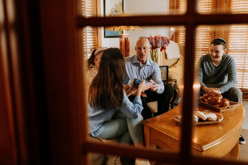 Photo Of Family Gathered In The Living Room 