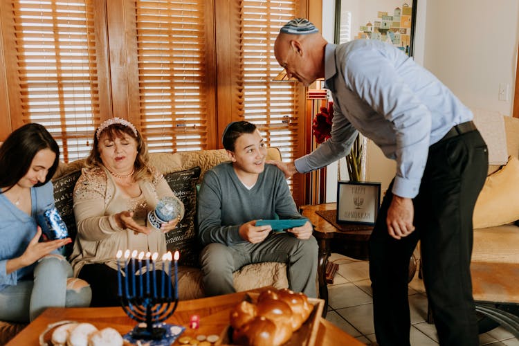 Photo Of A Family Exchanging Gifts