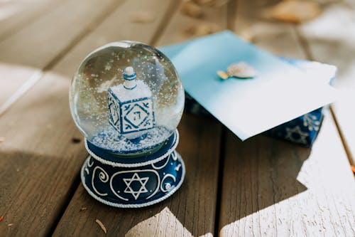 Close-Up Photo Of A Snow Globe On Wooden Surface