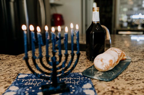 Black Wine Bottle on Blue and White Table Cloth