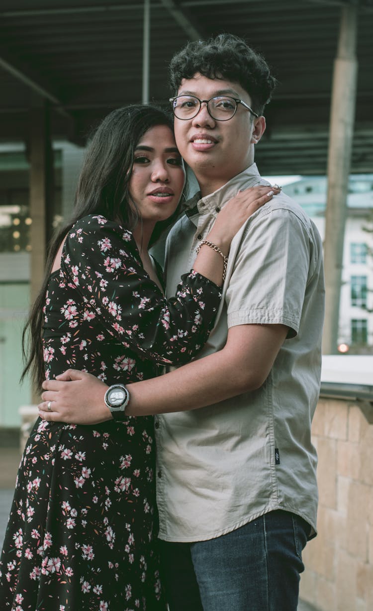 Man In Button Up Shirt Resting His Hand On Woman's Waist