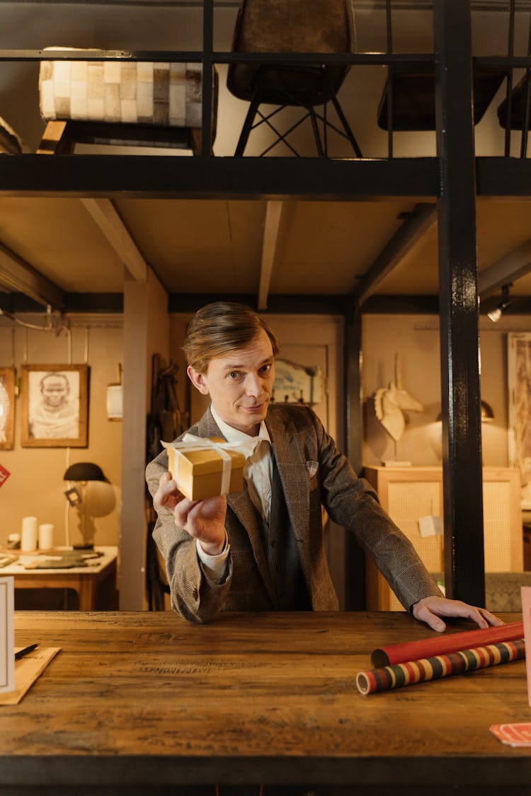 A Man Holding A Gift Box