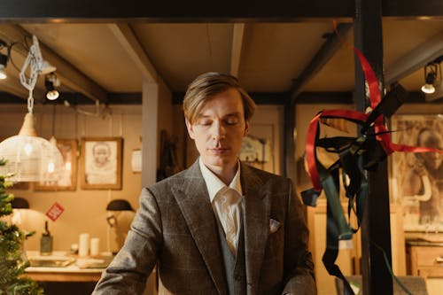 A Man in Gray Business Suit Manning the Store