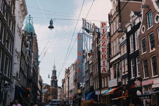 Explore the lively streets of Amsterdam featuring historic architecture and bustling city life.