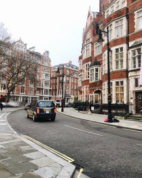 Discover a picturesque London street with historic buildings and classic architecture, ideal for urban travel enthusiasts.
