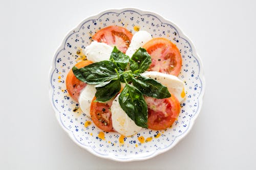 1989: Free Vegetable Salad on White and Blue Round Floral Plate Stock Photo