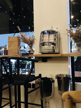 A cozy cafe in London featuring a vintage jukebox, rustic decor, and ambient lighting.