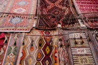 Colorful handmade weaved with oriental ornament middle east rugs hanging in open market