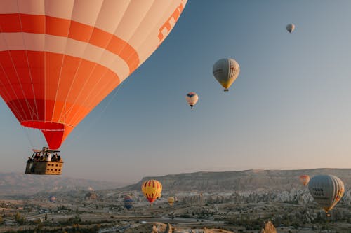 Colorful air balloons flying over old eastern city