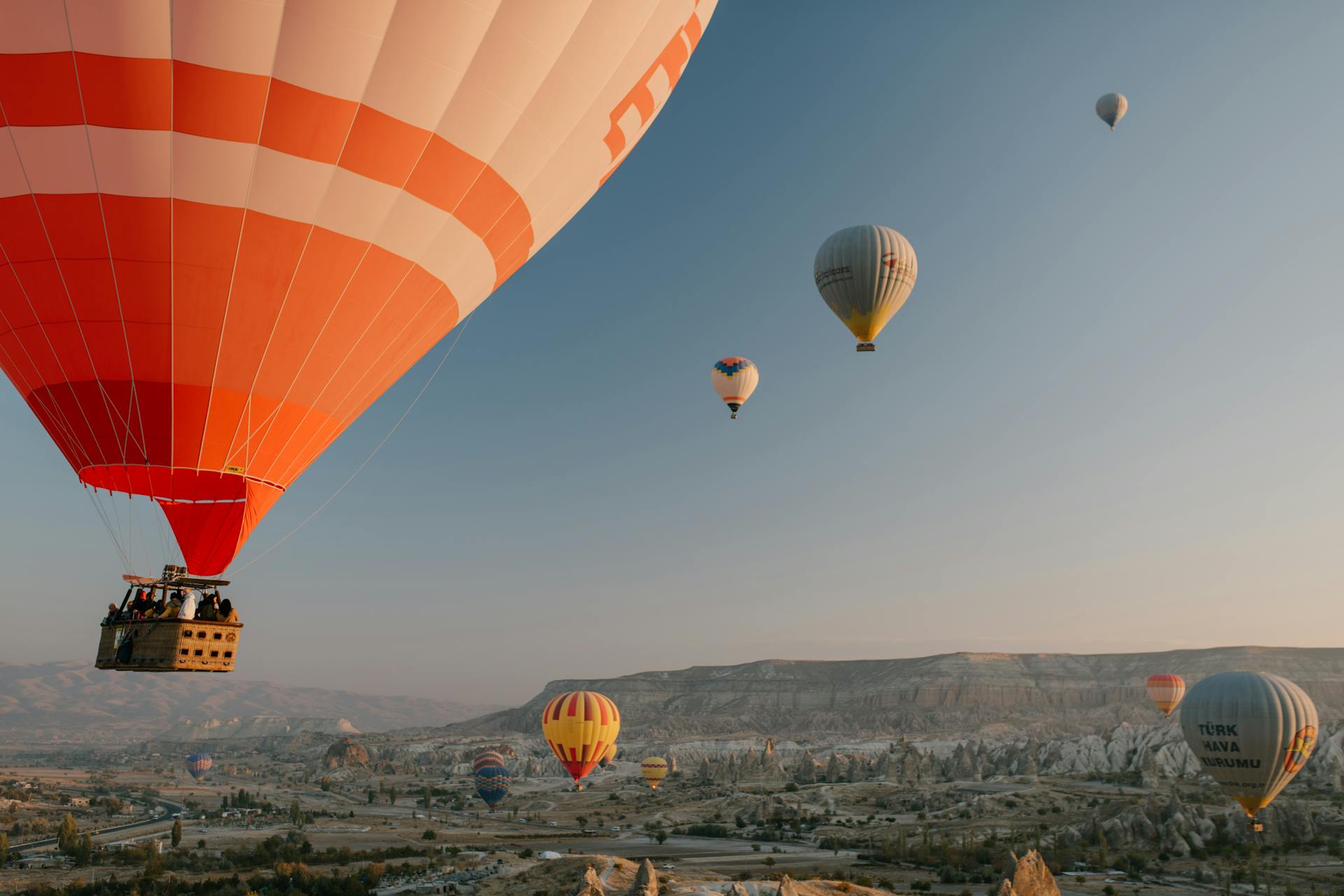 Colorful air balloons flying over old eastern city