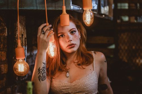 Free Artistic indoor portrait of a woman surrounded by vintage bulbs in Rio de Janeiro. Stock Photo