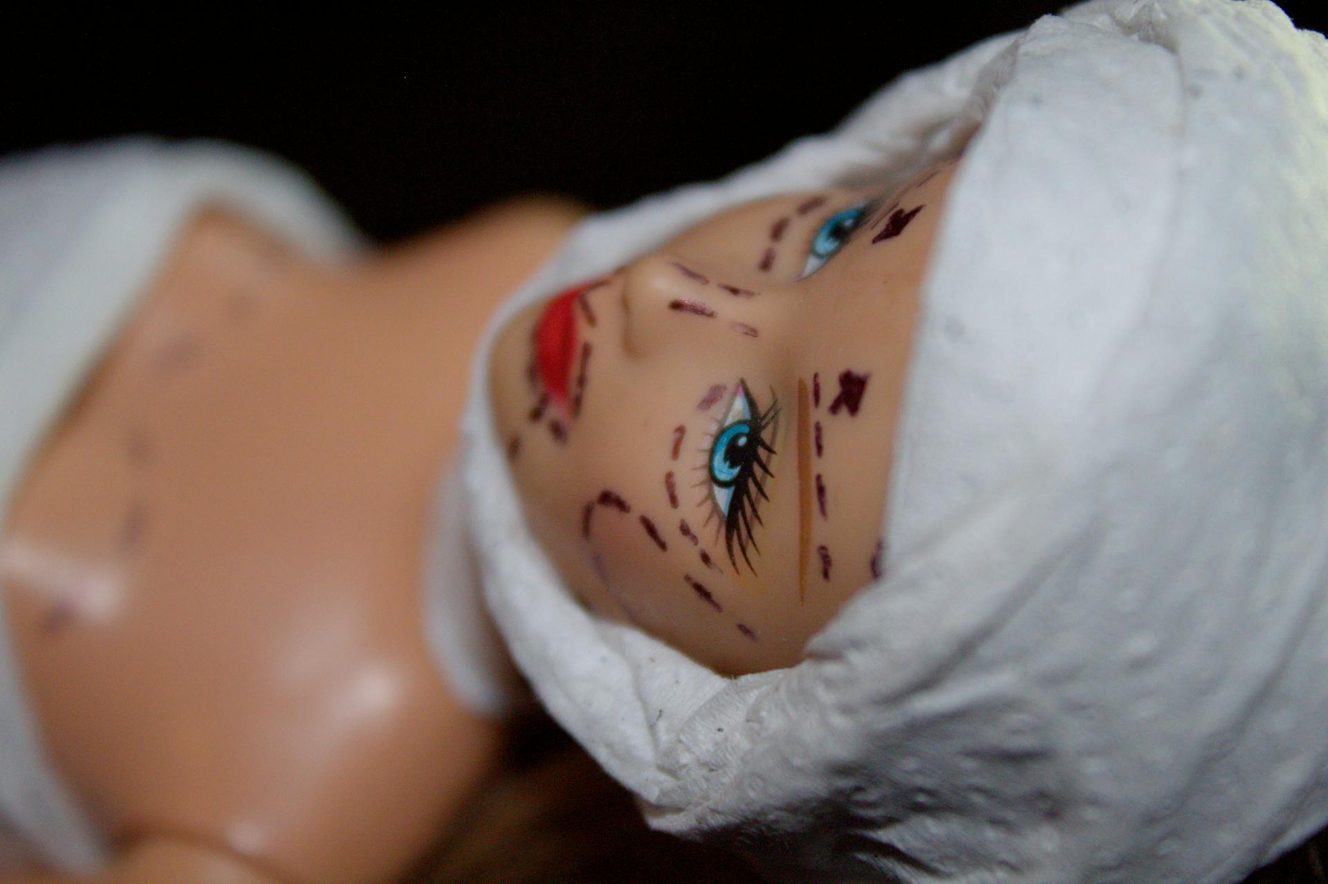 Conceptual image of a mannequin depicting plastic surgery with marker lines.