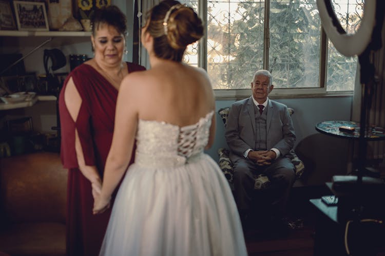 Bride With Her Parents In A Backroom 