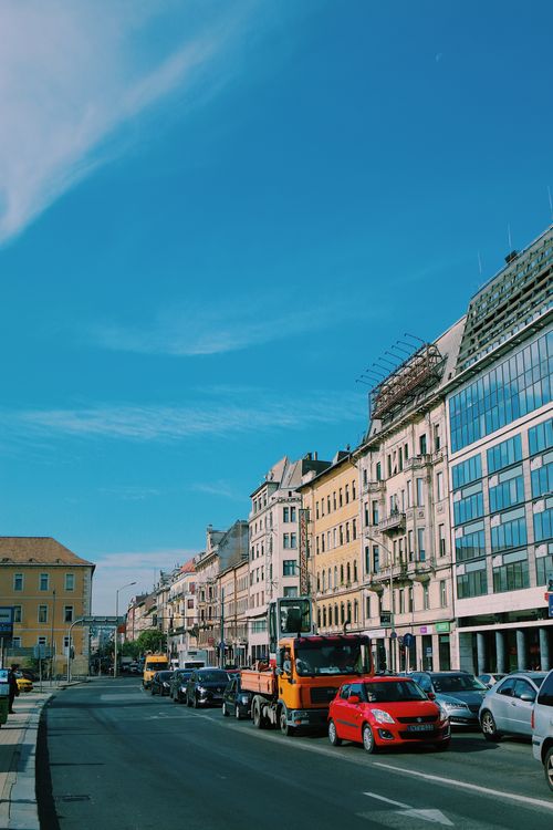Free Dynamic view of a bustling city street in Budapest, showcasing traffic and classic architecture under a clear sky. Stock Photo