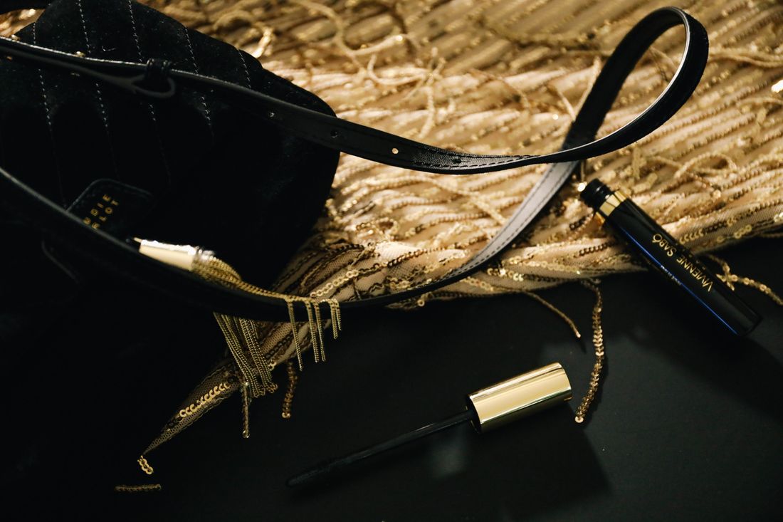 Close-up of an elegant black and gold handbag