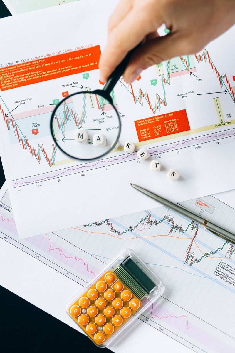 Magnifying glass over market data and charts