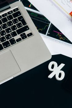 Close-up of a laptop keyboard with percentage symbol, representing financial analysis and investment concepts.
