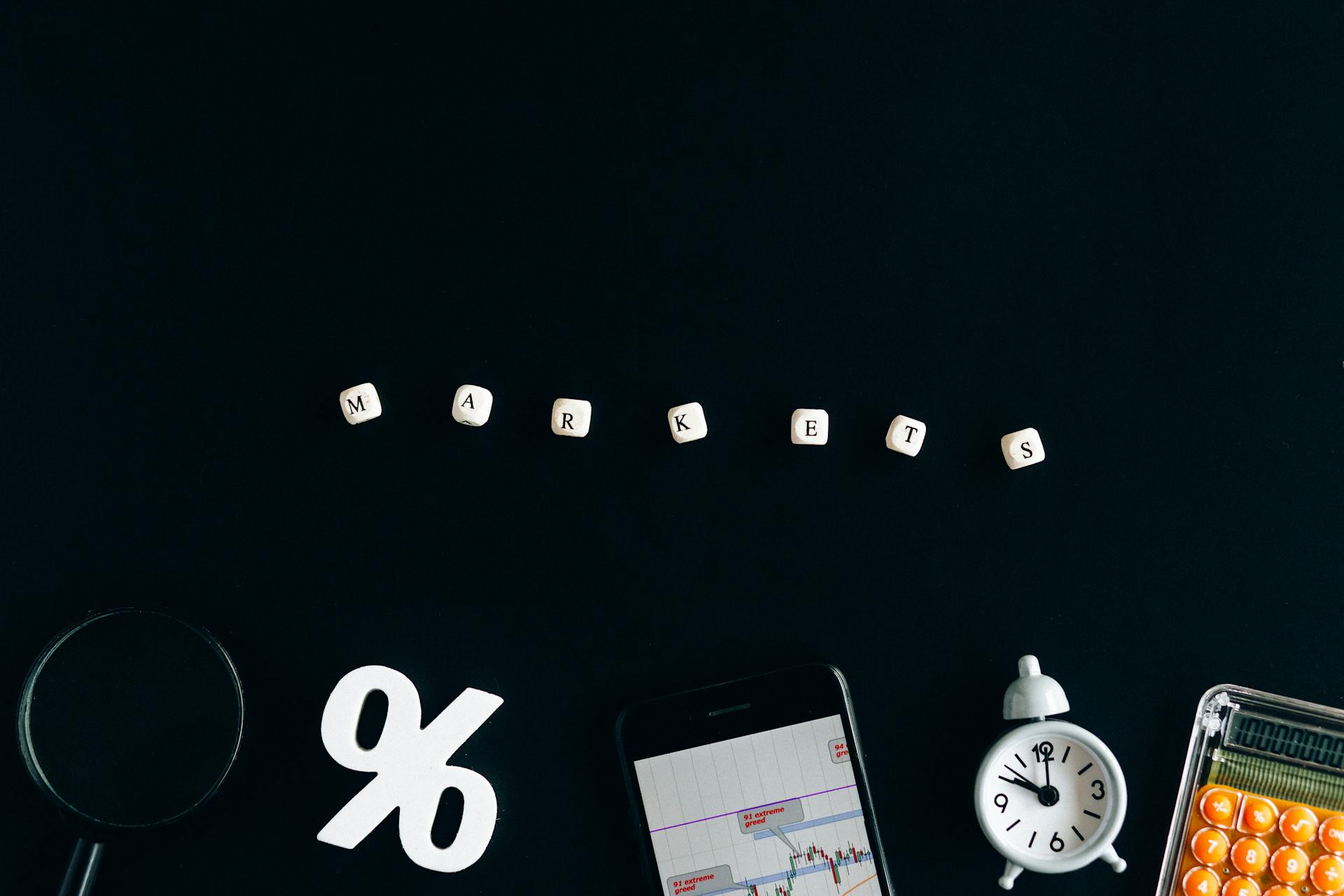 Creative arrangement depicting financial markets with cubes, graphs, and a clock on a black background.