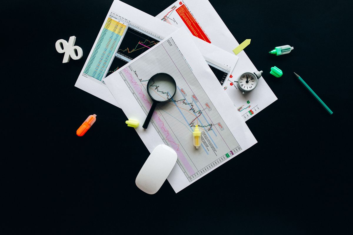 Magnifying glass on professional documents representing focused Fractional CHRO support