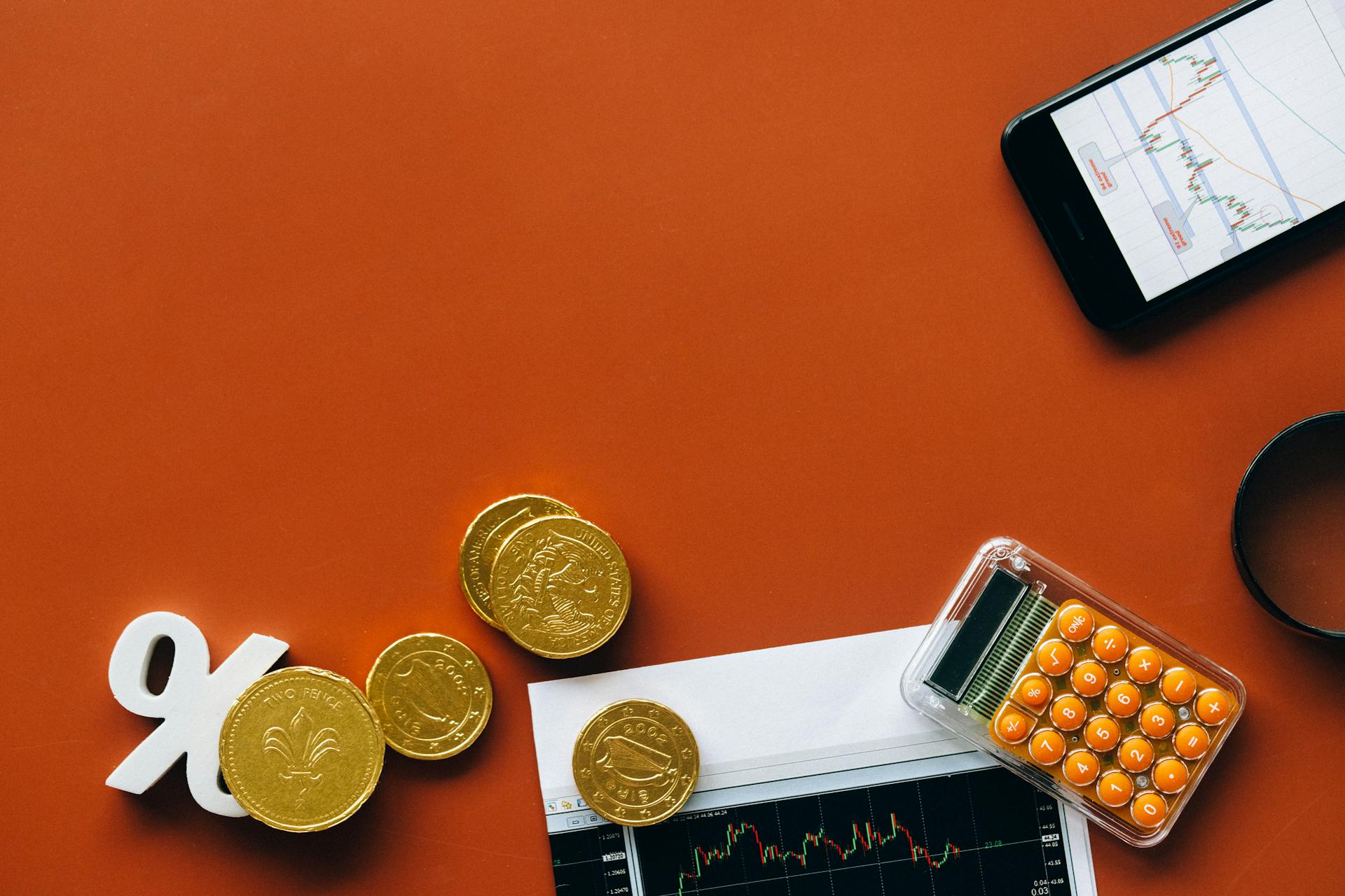 Coins and Financial Graphs on Red Background