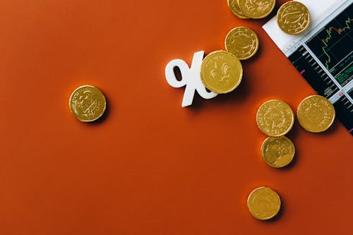 Gold Coins on Orange Background