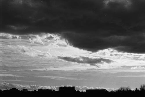 Free Grayscale Photo of Clouds Over City Buildings Stock Photo