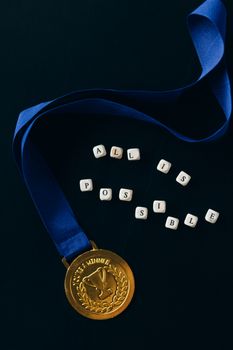A gold medal with a blue ribbon and 'All is Possible' text on a dark background.
