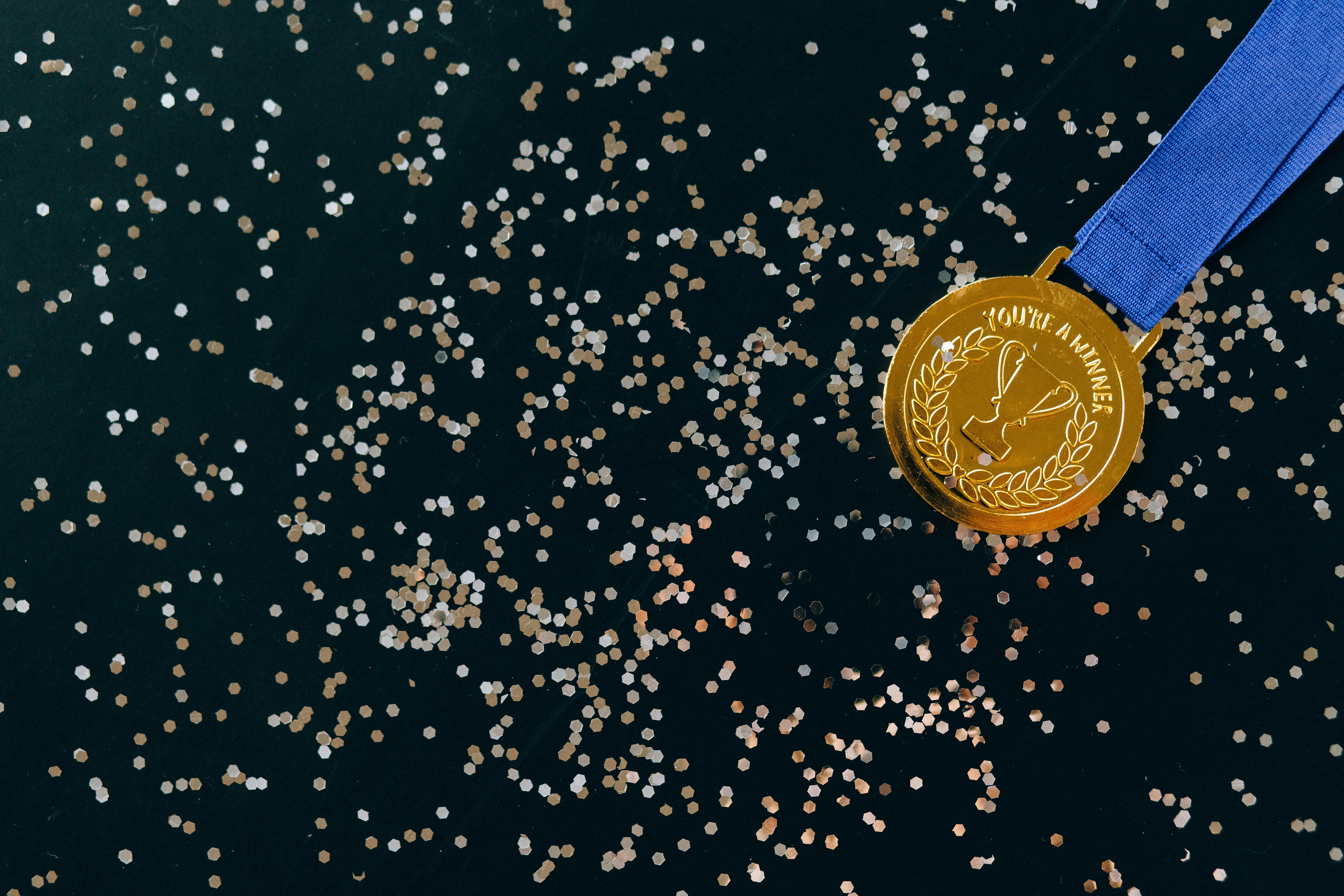 close up shot of a gold medal on a black surface