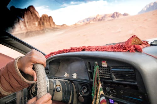 Free Person Driving a Car on the Desert Stock Photo