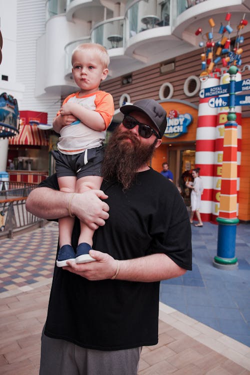 Free Bearded Man Carrying a Boy Stock Photo