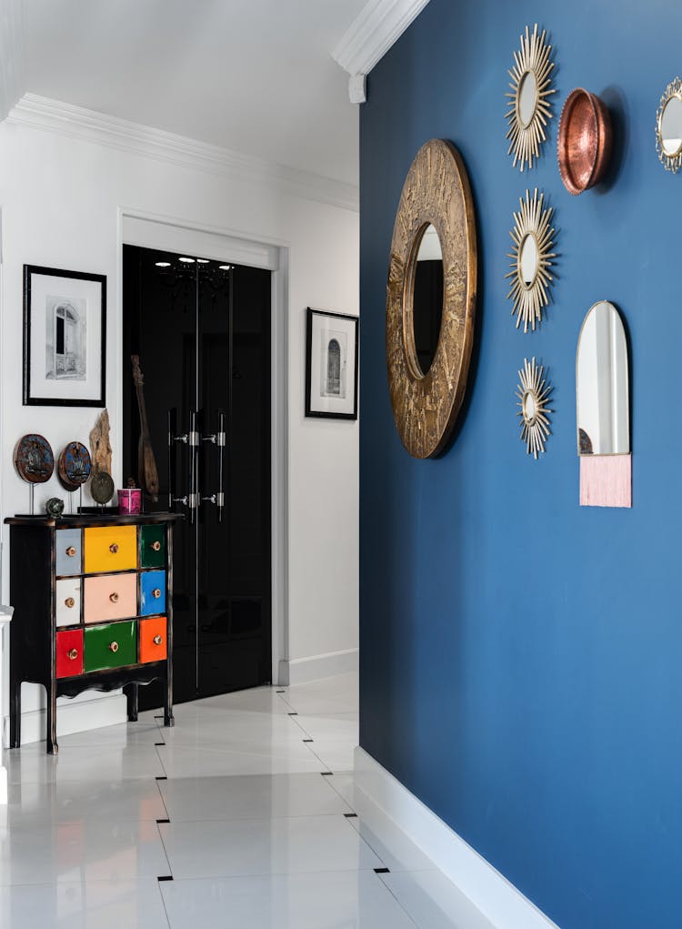 Interior Of Modern Room With Blue Wall Decorated With Mirrors