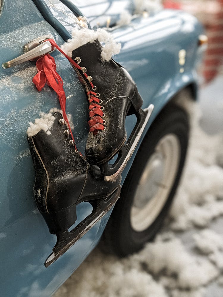 A Black Ice Skates Hanging On A Cars Dorr Handle