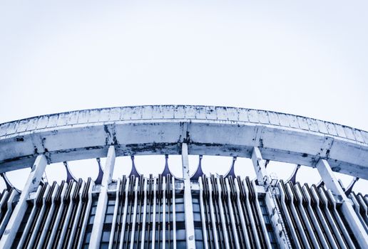 Dynamic low-angle shot highlighting the unique design of a modern stadium's exterior structure.