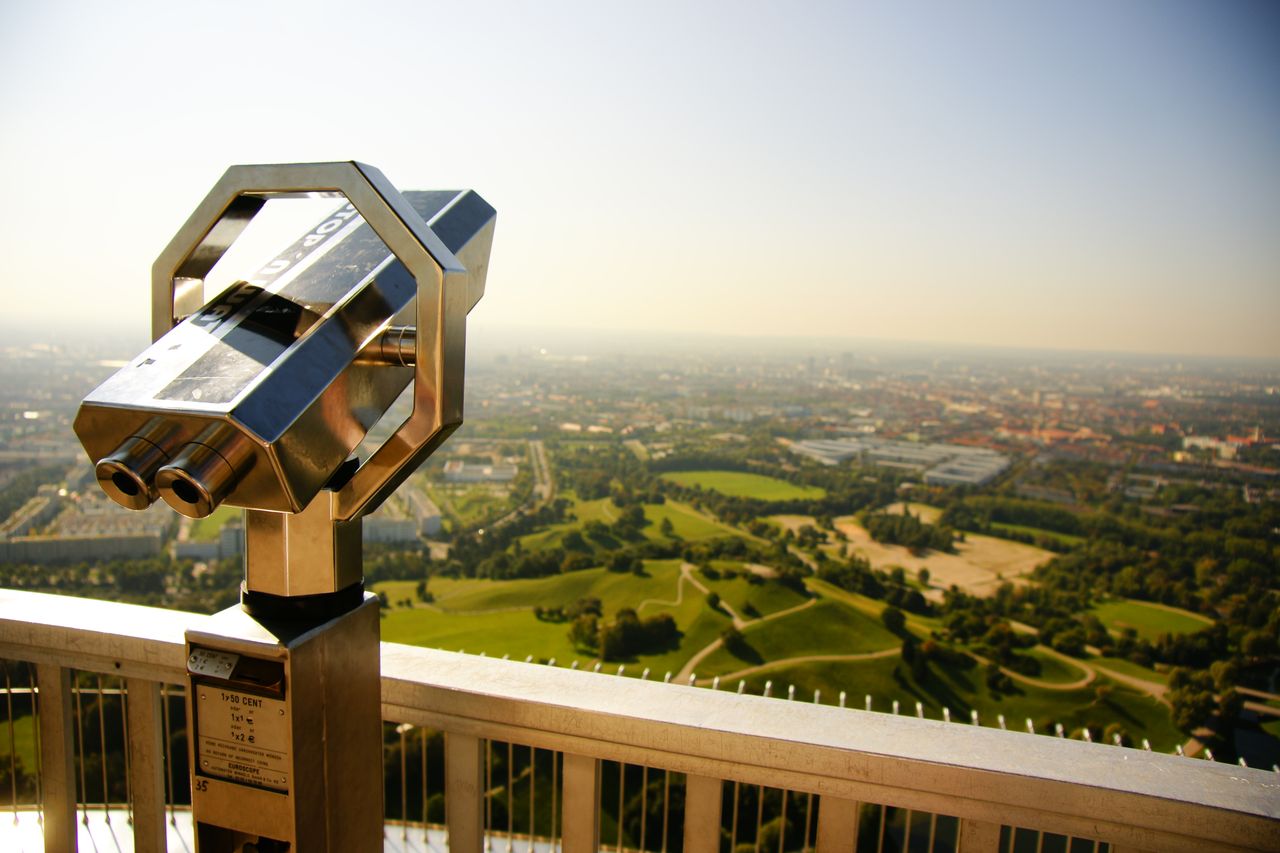 scenic view of munich skyline and green hills from an observation plat