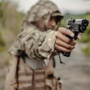 Crop soldier aiming gun in countryside