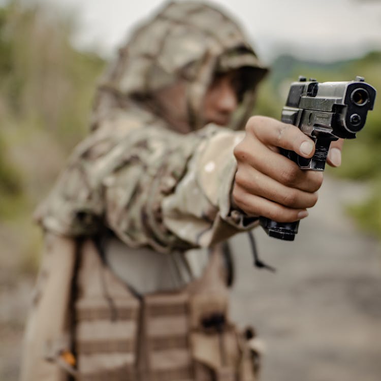 Crop Soldier Aiming Gun In Countryside