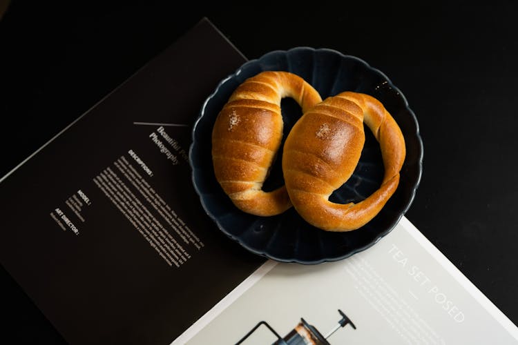 Brown Crab Shaped Breads On Black Saucer