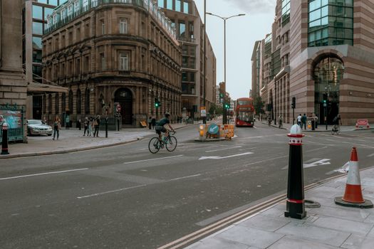 Man in Black Jacket Riding Bicycle on Road