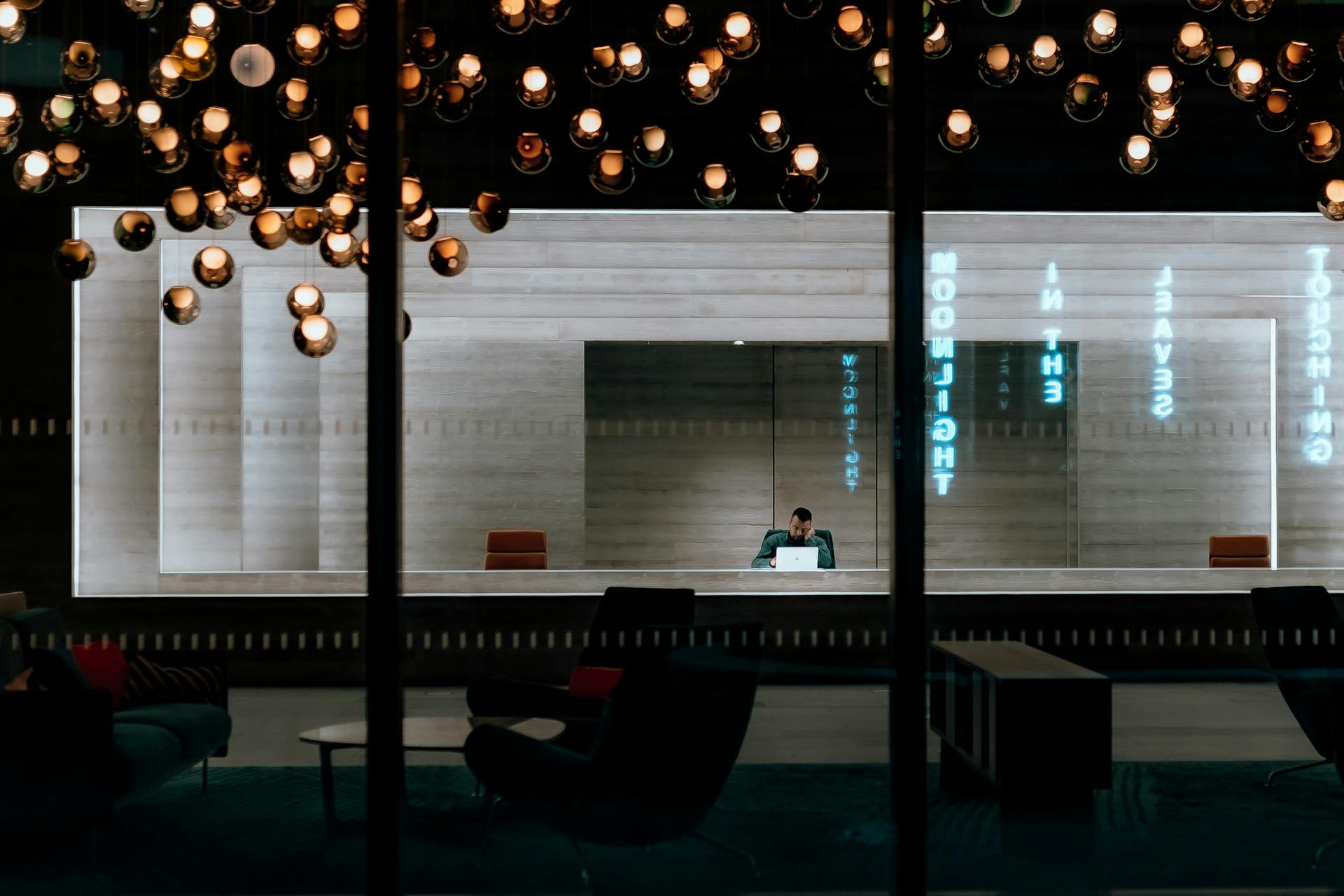 A stylish office lobby featuring pendant lighting and reflection effects in modern interior design.