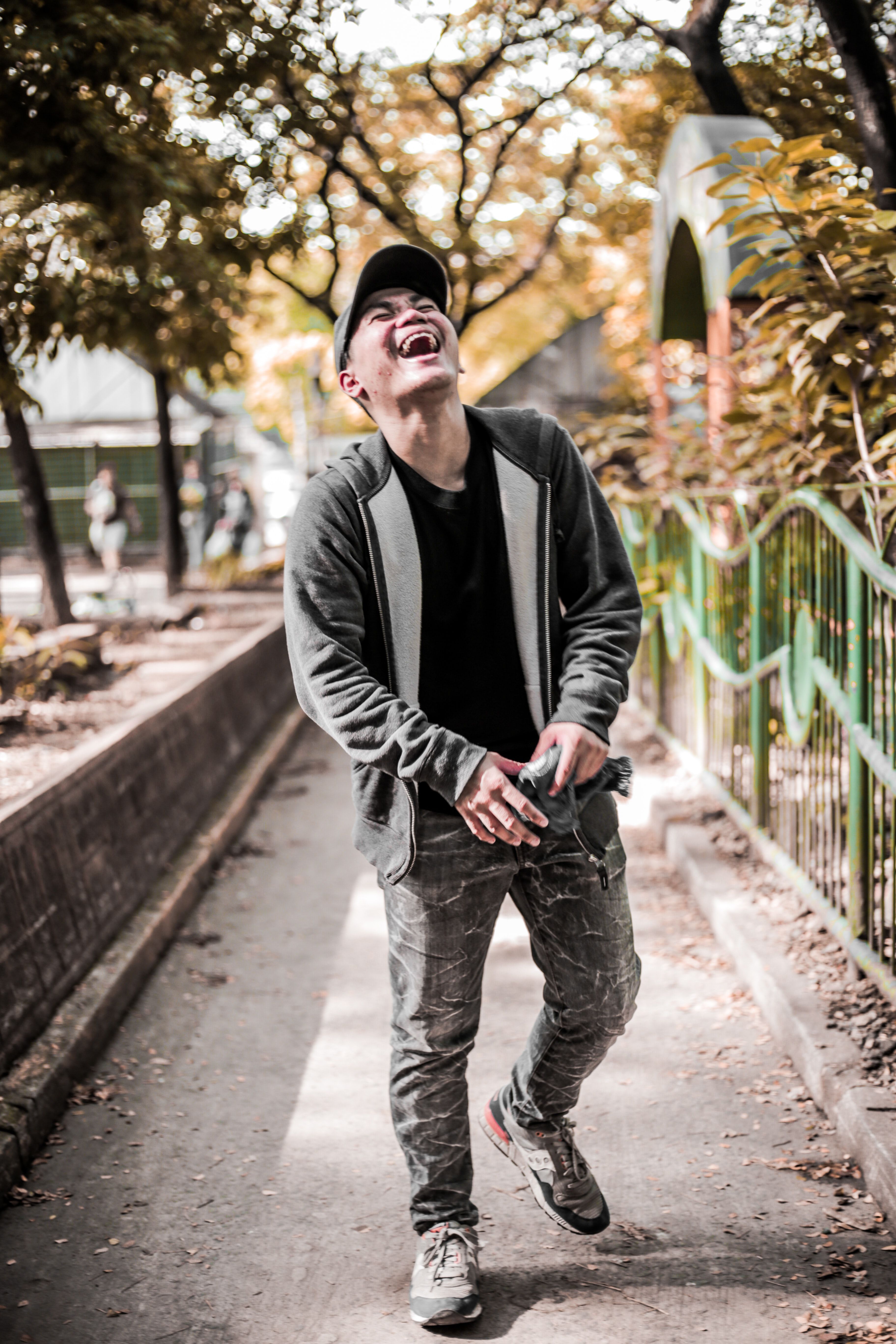 A Man Wearing Cap Backwards Laughing · Free Stock Photo