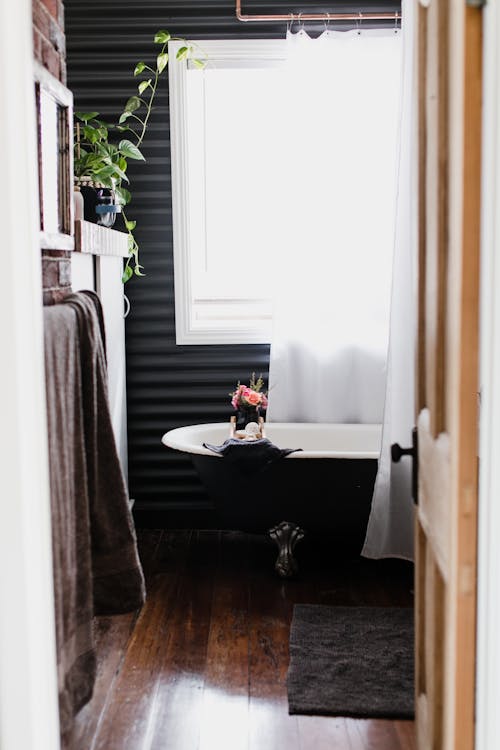Free Simple Bathroom Design With Black and White Ceramic Bathtub Stock Photo
