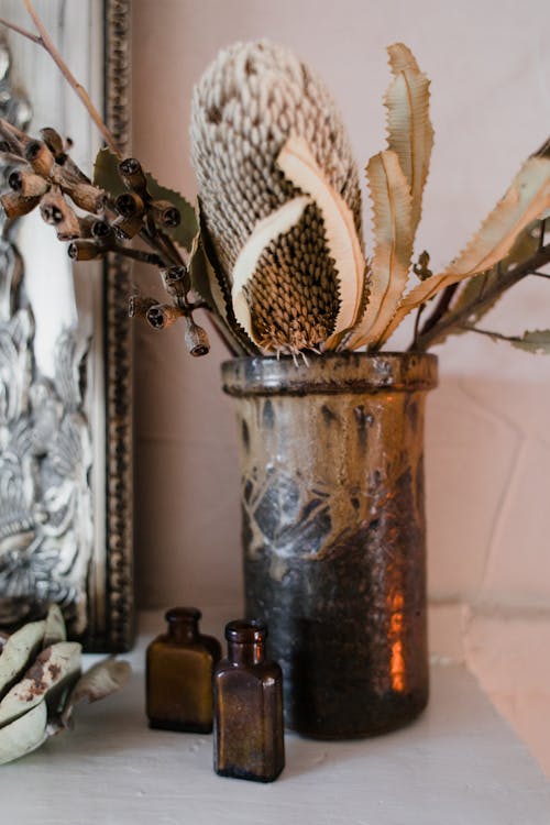 Brown Glass Vase With Dried Leaves