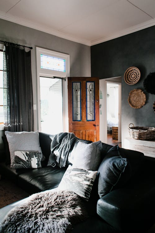 Living Room With Gray and White Throw Pillows on Black Couch