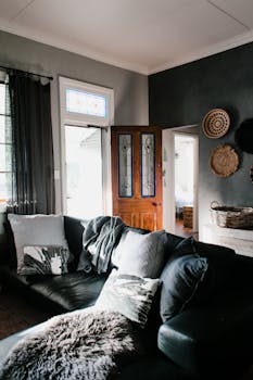 Warm and inviting living room featuring a plush sofa, elegant decor, and abundant natural light.