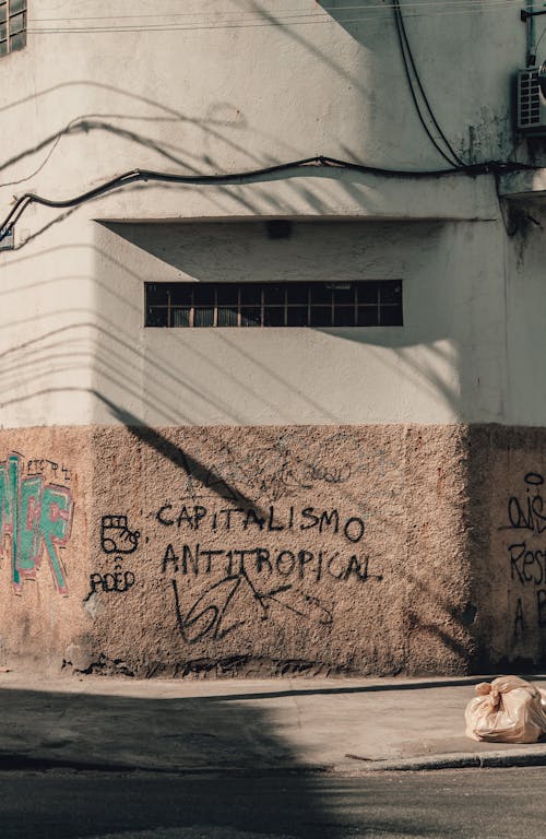 Free Old stone building with graffiti on wall in sunny day Stock Photo