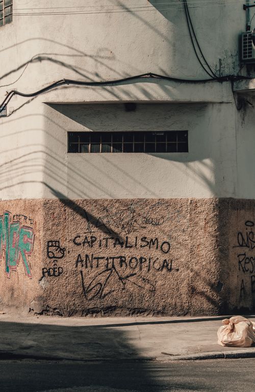 Free Exterior of shabby concrete building with graffiti inscription on wall in sunny day Stock Photo