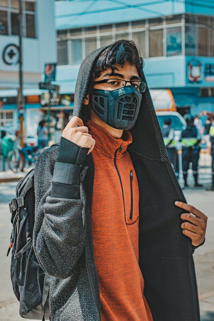 Person In Black Hoodie Wearing Black Face Mask