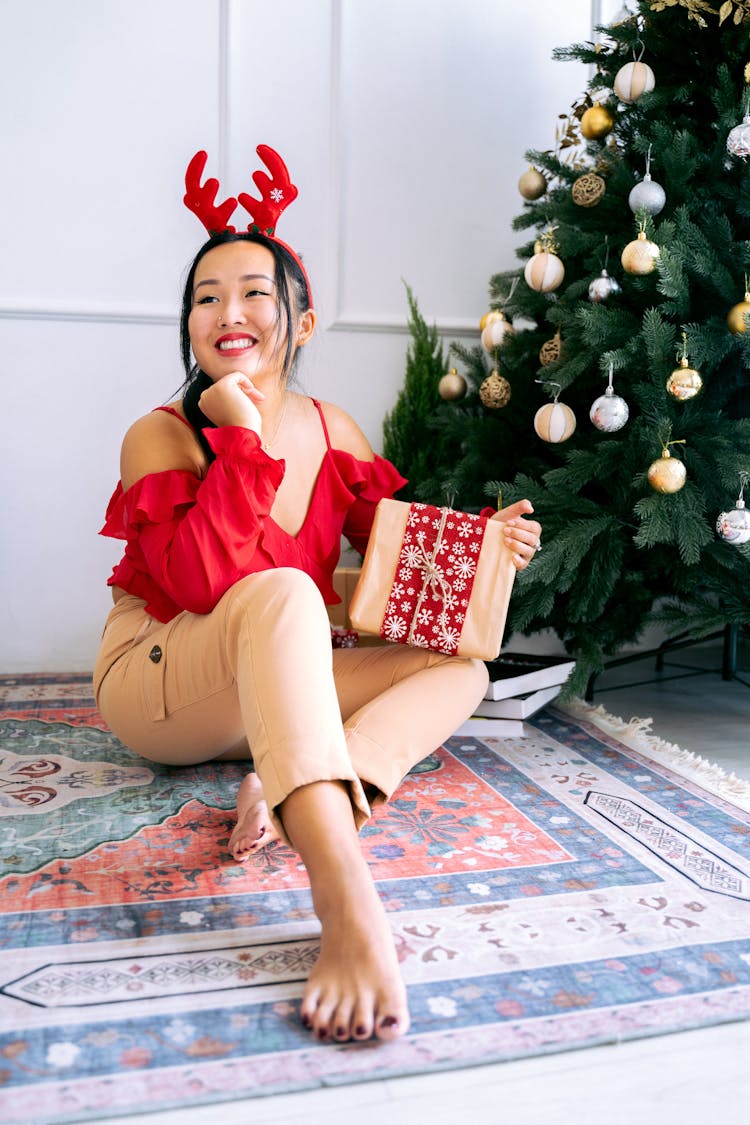 Woman In Red Off Shoulder Blouse Holding Christmas Present