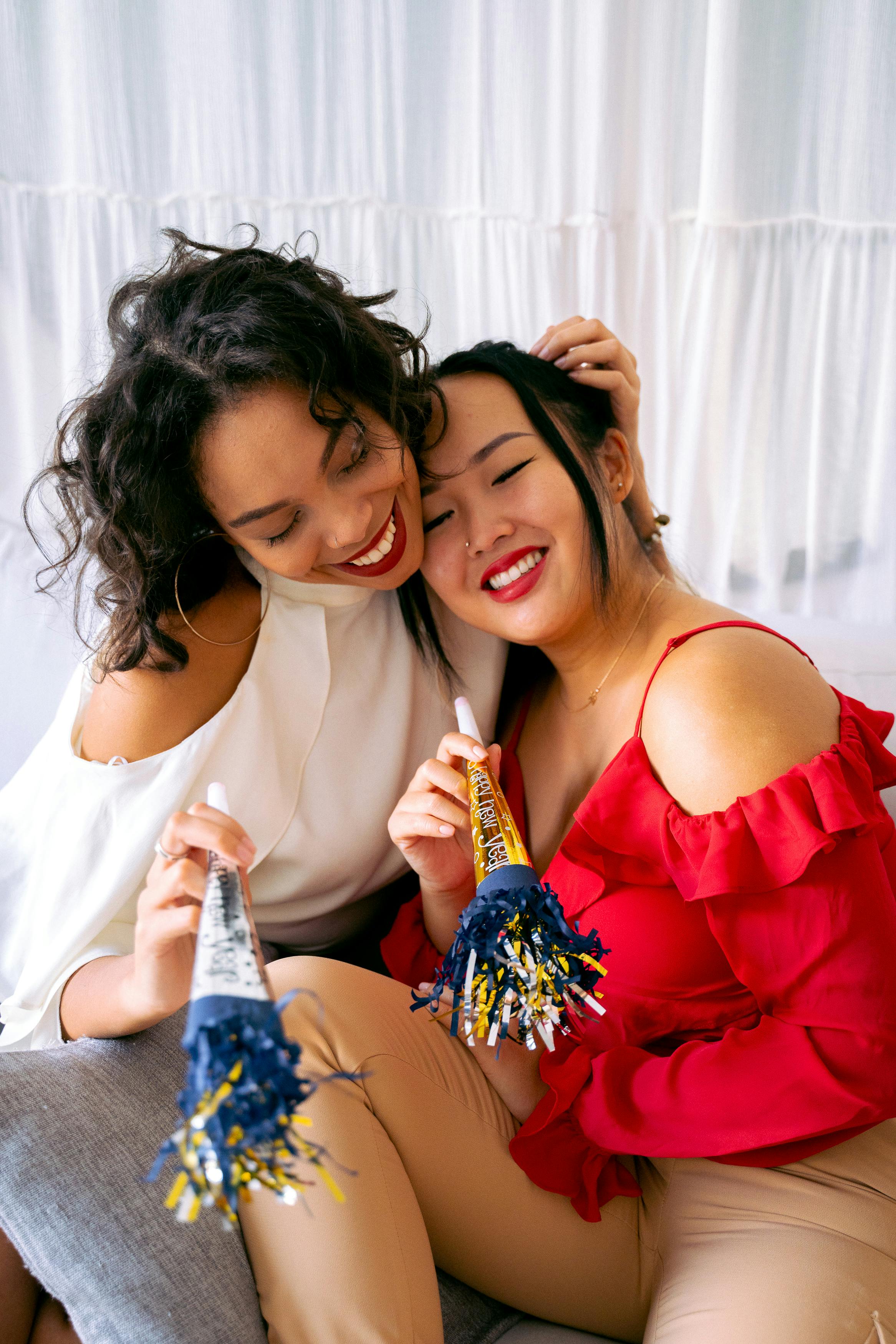 women holding new year trumpets